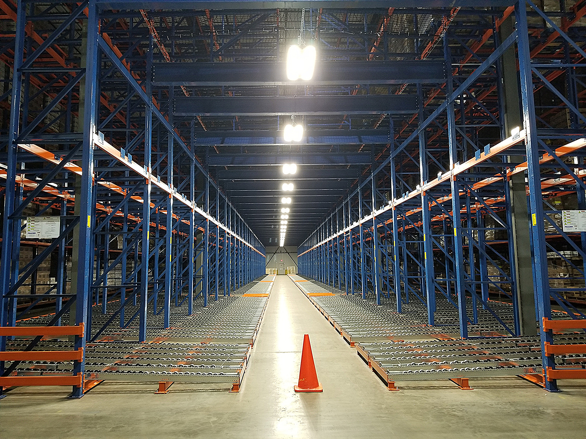 Caution cone in an aisle between pallet racks