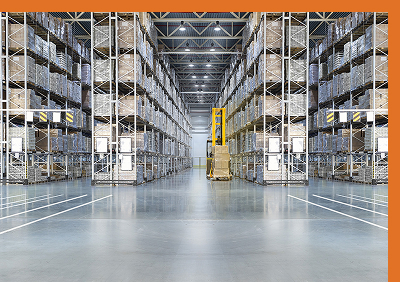 Organized warehouse with several rows of pallet racks stacked with boxes
