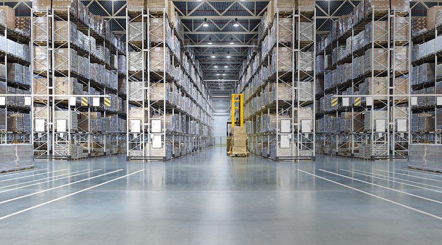 Organized warehouse with several rows of pallet racks stacked with boxes