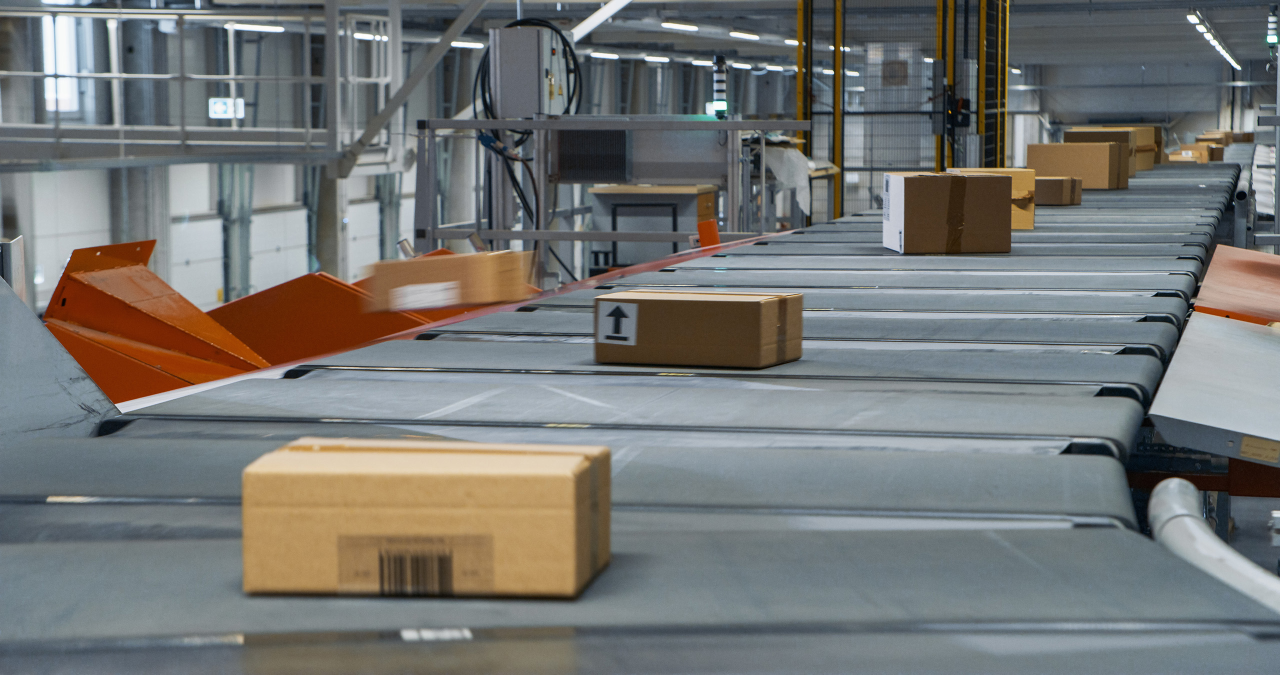 cardboard box traveling on warehouse conveyor