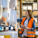 Woman stocking warehouse shelves