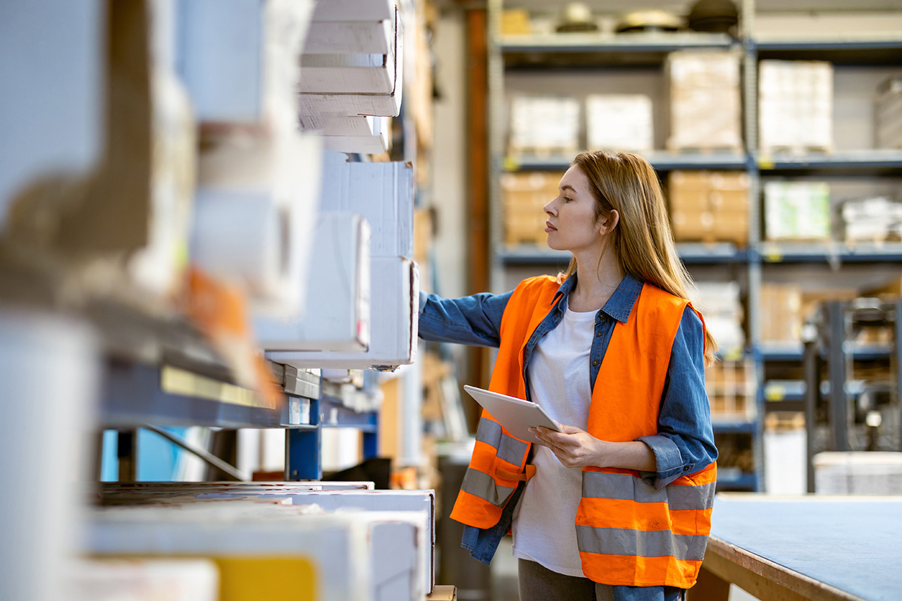 Woman with tablet in warehouse