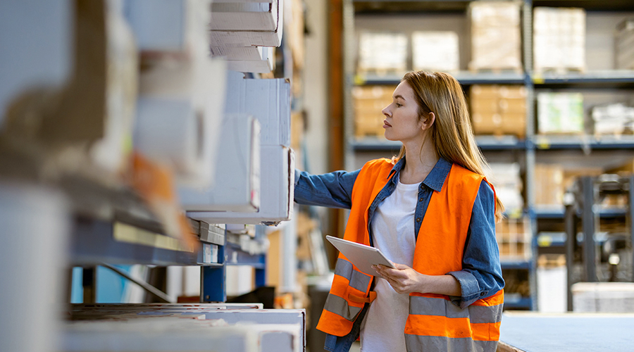 Woman stocking warehouse shelves