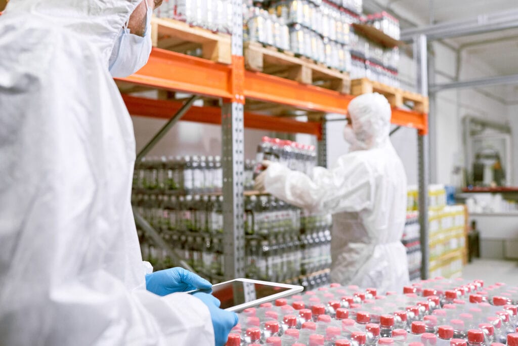 People in protective gear working in a warehouse