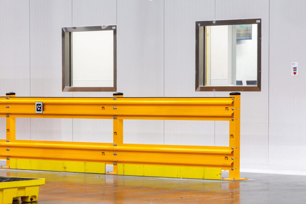cold storage warehouse interior with colorful safety rails and window on insulated walls